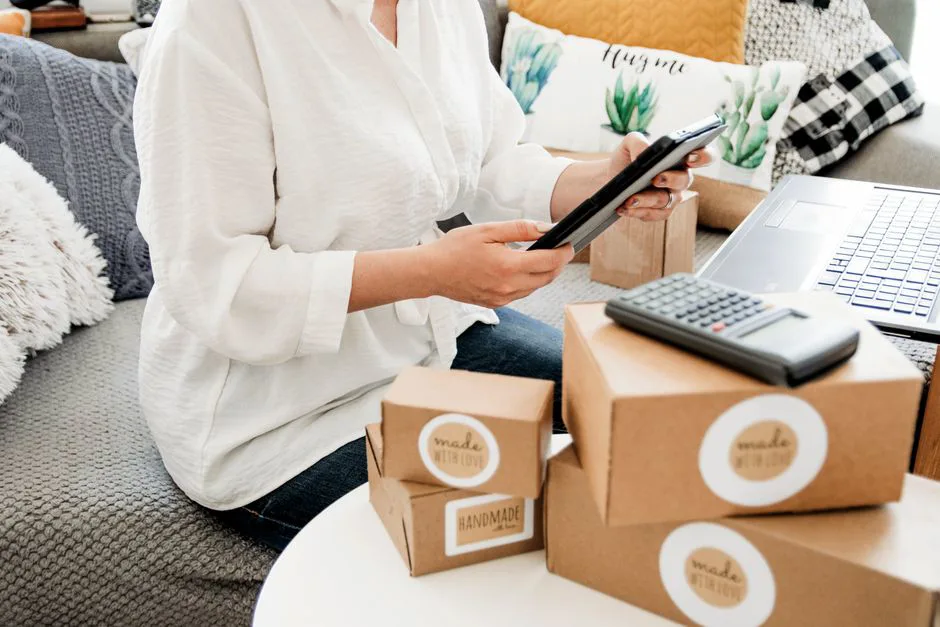 Stack of cardboard boxes with customs documents and a digital manifest on a tablet