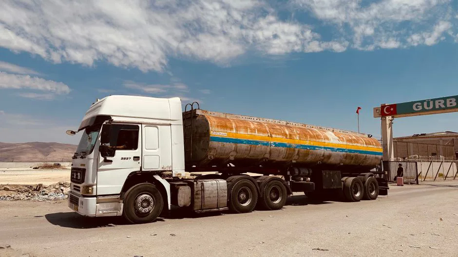 Delivery truck crossing US-Mexico border with customs documents